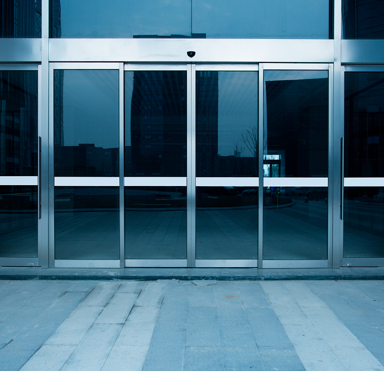 Empty walkway by glass facade